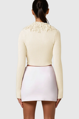 Aimee – Tief ausgeschnittenes Strickoberteil mit Fransen in Aprikose