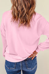 Rosa Weihnachts-Sweatshirt mit süßem Nussknacker-Print und überschnittener Schulter